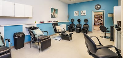 Interior view of a salon area with black chairs