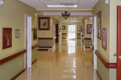 Bright interior hallway with artwork and polished floors