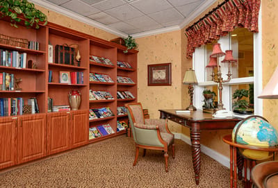 Cozy reading area with shelves of books and a desk