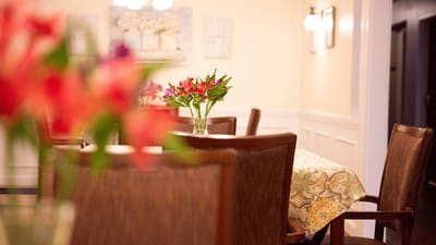 Interior view of a dining room with flower arrangements