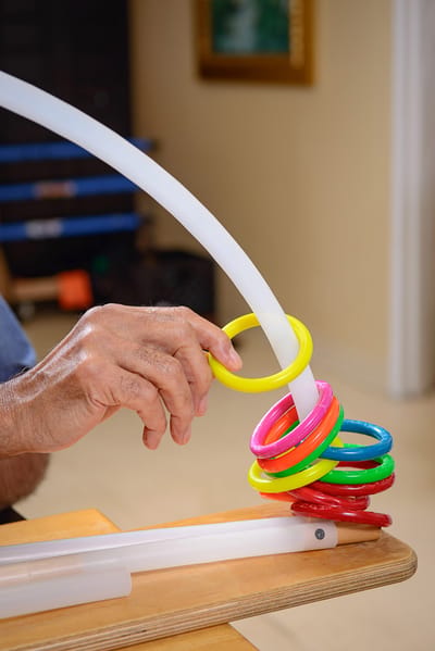 A resident engaging in a ring stacking activity