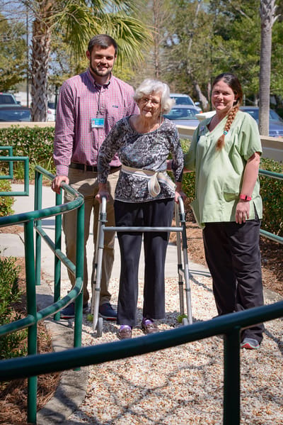A staff member assisting a resident outdoors