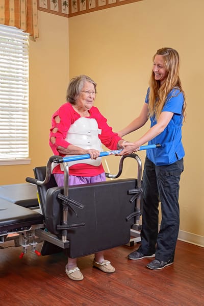 Staff assisting a resident with mobility activity