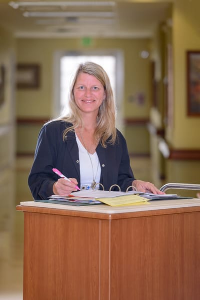 Staff member assisting in the facility's hallway