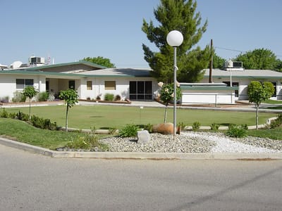 Exterior view of Mayflower Gardens with landscaping