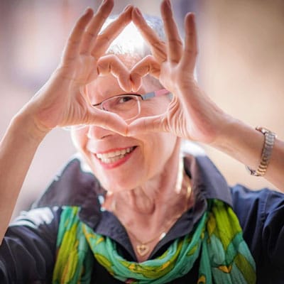 Senior resident making a heart shape with hands