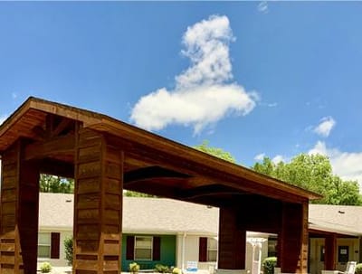 Exterior view of the facility entrance with wooden canopy