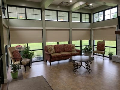 Bright common area with seating and large windows
