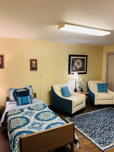 Cozy resident room with bed and seating area