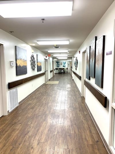 A well-lit corridor with artwork on the walls