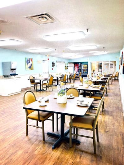 Dining area with tables and chairs in a bright room