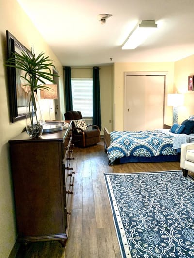 Interior view of a private resident room with furniture