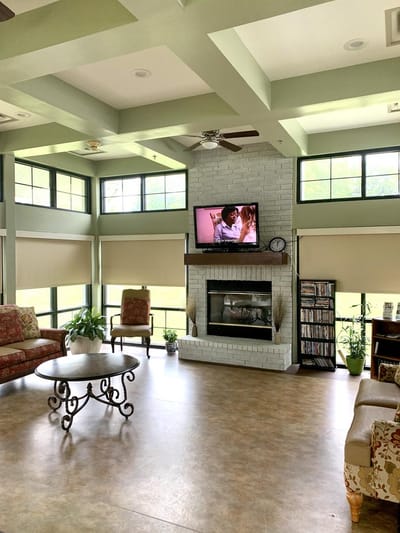 Bright common area with seating and a TV