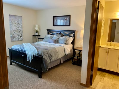 Cozy interior of a resident's room with a bed and bathroom