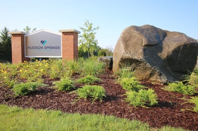 Signage for Hudson Springs Nursing & Rehab surrounded by landscaping