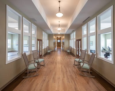 Bright hallway with rocking chairs and windows