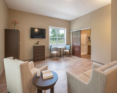 Cozy resident room with furniture and window