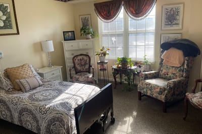 A well-furnished resident room with bright natural light