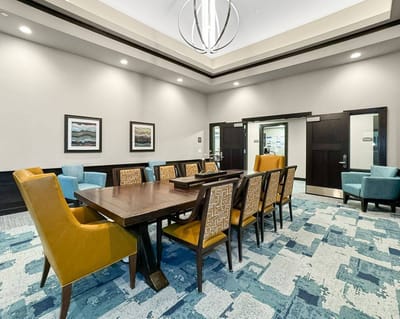 Bright common area with large dining table and seating