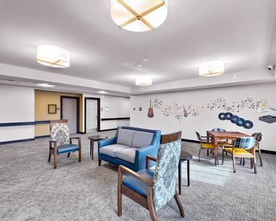 Bright common area with seating and musical decor