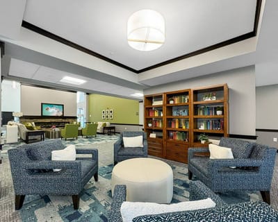 Interior view of a common area with seating and bookshelves