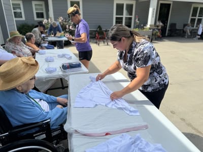 Staff assisting residents with activities outdoors