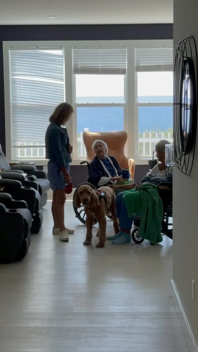 Residents in a common area with a dog