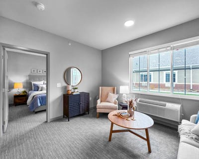 Bright interior room with a bed and seating area