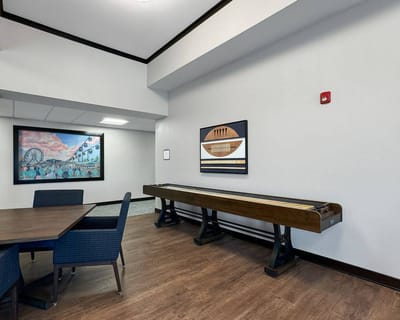 Interior common area with a shuffleboard table
