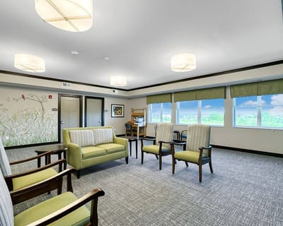 Bright common area with green and beige furnishings