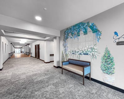 Interior hallway with decorative mural and seating area