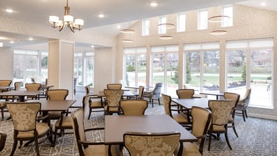 Bright dining area with large windows and tables