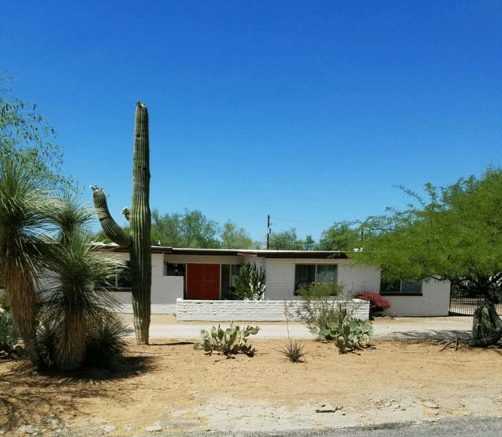 Exterior view of an assisted living facility with desert landscaping.