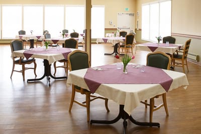 Dining room setup with tables and flowers
