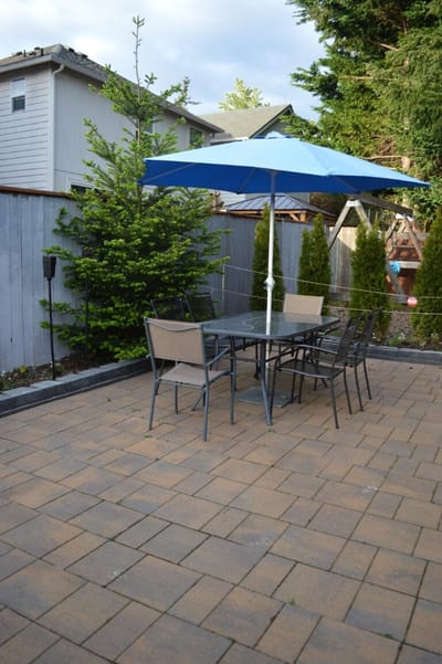 Outdoor patio area with table and umbrella