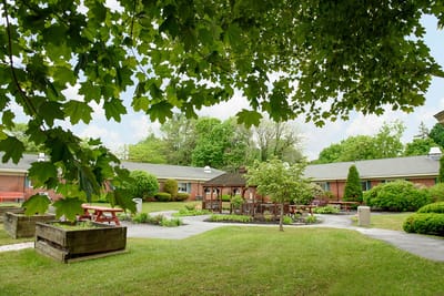 Well-maintained outdoor courtyard with seating areas and gardens