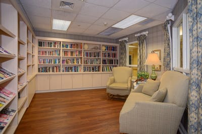 Cozy reading area with bookshelves and comfortable chairs