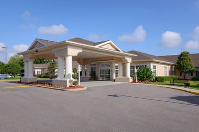 Front entrance of a senior living facility with landscaping
