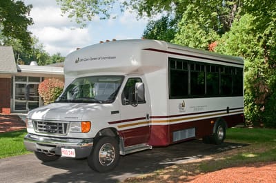Facility transport vehicle parked in front of the building