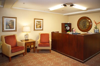Reception area with seating and a clock