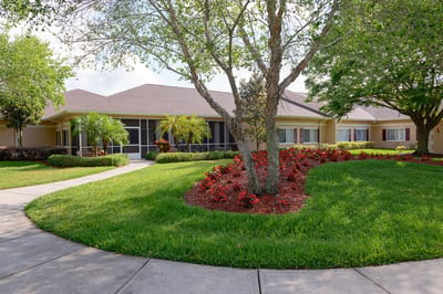 Exterior view of a pleasant assisted living facility with gardens