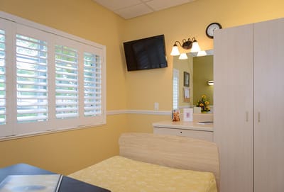 Cozy interior of a resident room with a bed and decor