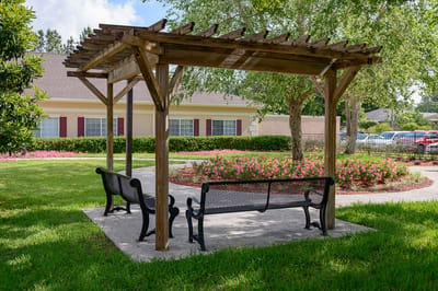 Outdoor seating area with pergola and landscaping