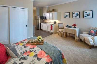 Cozy resident room with kitchenette and seating area