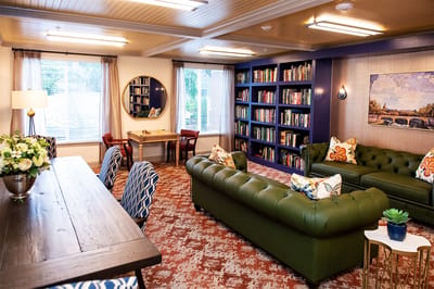 Cozy common area with bookshelves and comfortable seating