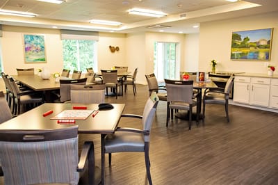 Bright activity room with tables and chairs