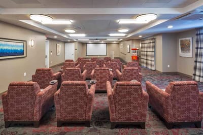 Interior view of a common area with seating and a projector