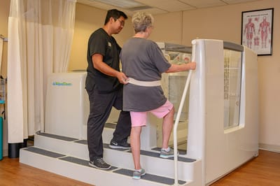 A staff member assisting a resident in a therapy session