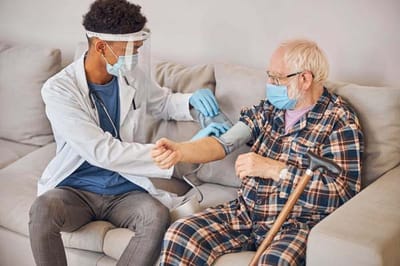 Lorien Bulle Rock, Nursing Home in Havre De Grace, MD — Healthcare professional taking blood pressure of elderly man
