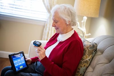 Senior woman using a tablet in a cozy living area